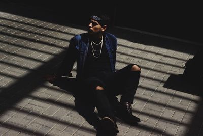 Young man sitting on staircase