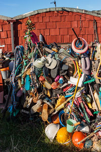 Close-up of garbage can against built structure