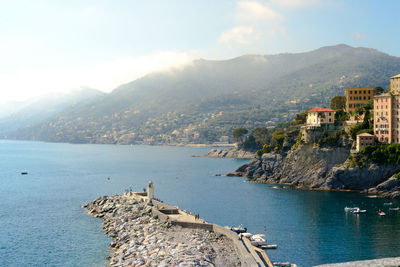 Scenic view of sea by city against sky