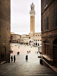 People walking on piazza del campo siena