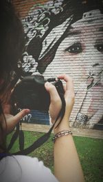High angle view of woman photographing through smart phone