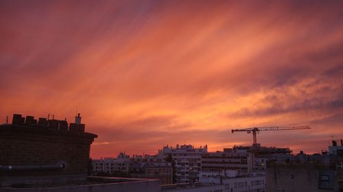 Silhouette buildings against sky during sunset