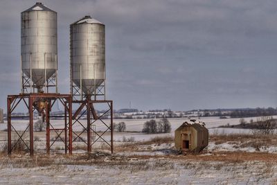 Built structure on snow field against sky