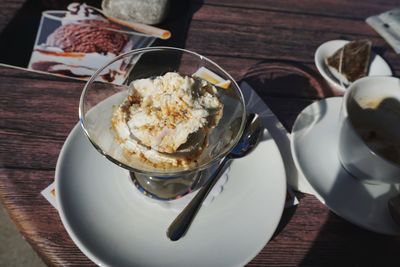 High angle view of coffee and cake on table