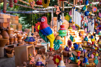 Close-up of multi colored decorations hanging for sale in market