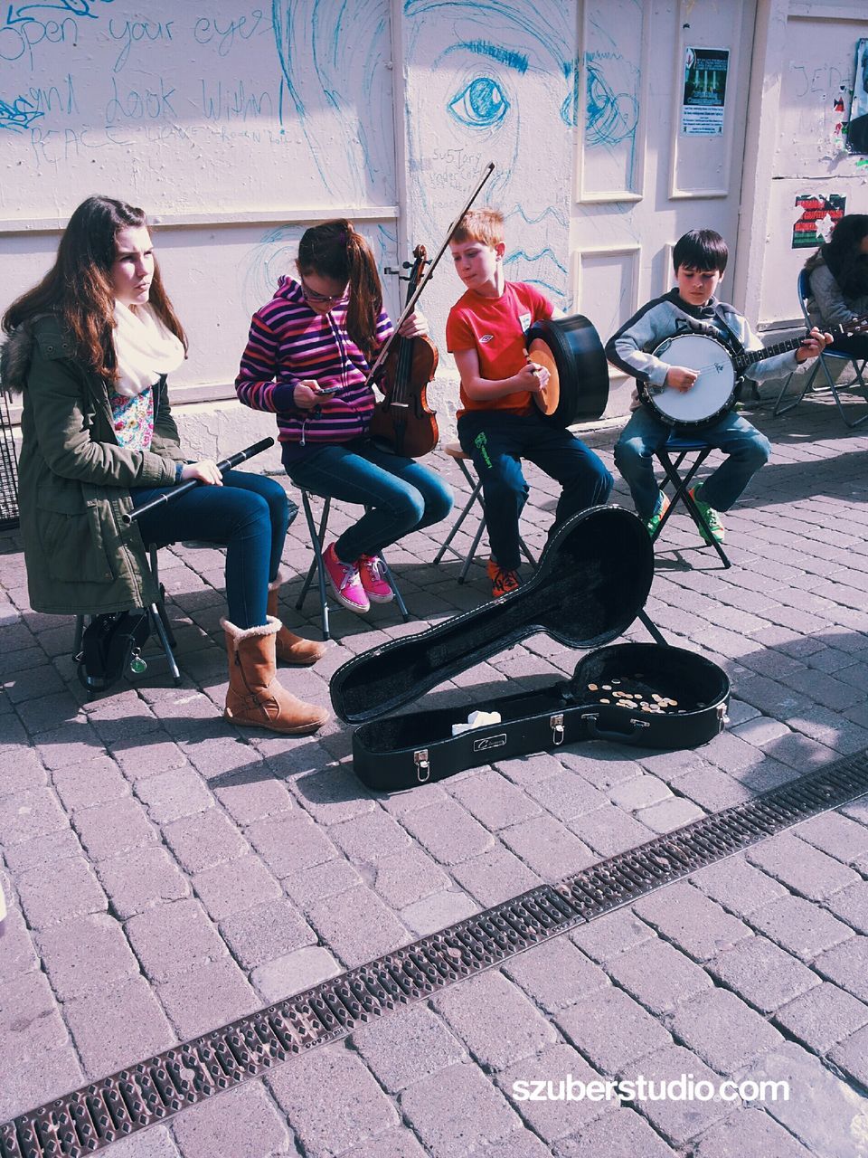 lifestyles, leisure activity, men, sitting, street, person, casual clothing, shadow, full length, sunlight, land vehicle, togetherness, transportation, city, young adult, day, city life