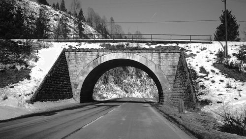 Road amidst trees against sky
