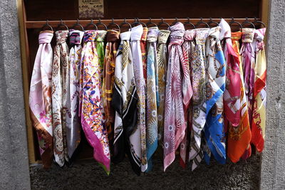 Various clothes hanging in market stall