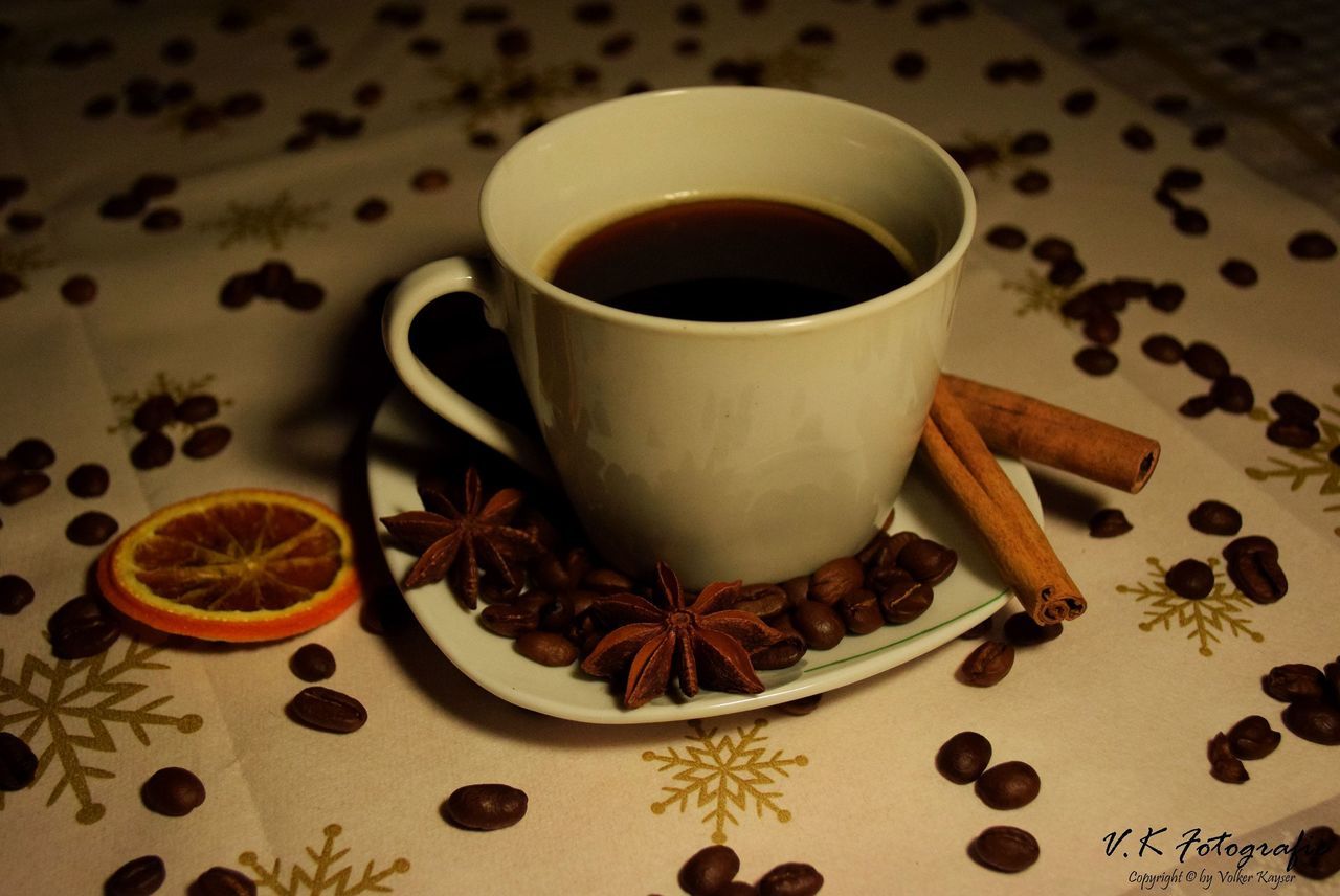 CLOSE-UP OF COFFEE CUP AND SPOON ON TABLE