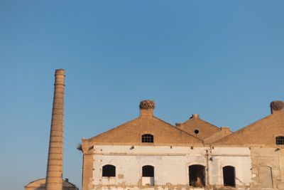 Low angle view of historic building against clear blue sky