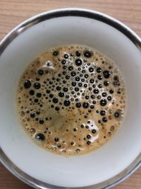 High angle view of coffee in cup on table