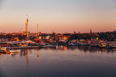 Panoramic view of illuminated buildings against sky at sunset