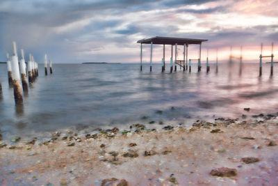 Lifeguard hut on beach against sky