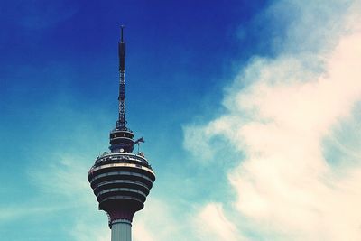 Low angle view of communications tower against blue sky