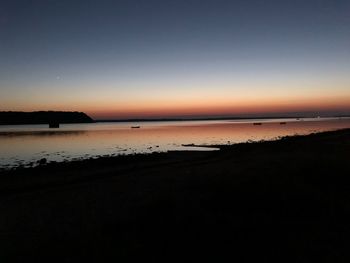 Scenic view of sea against clear sky during sunset