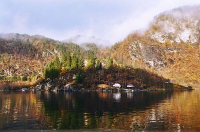 Scenic view of river by trees against sky