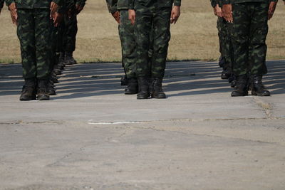 Low section of soldiers walking on road