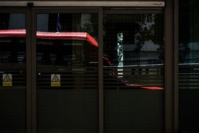 Reflection of building on glass window at night