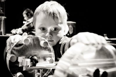 Little boy playing with machinery in laboratory