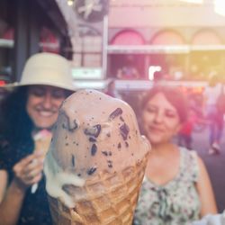 Close-up of smiling young woman with ice cream
