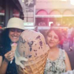 Close-up of smiling young woman with ice cream