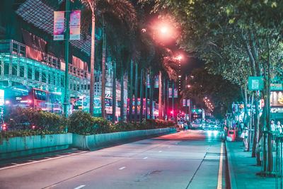 Illuminated city street at night