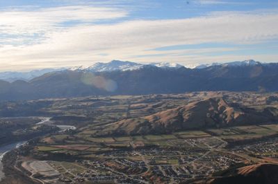 Aerial view of landscape with mountain range in background