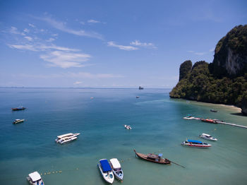 Boats moored in sea against sky