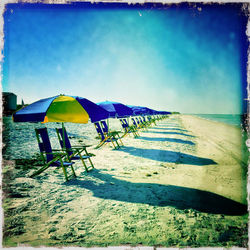 Scenic view of beach against blue sky