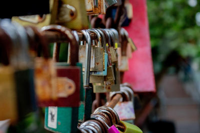 Close-up of padlocks hanging on metal railing