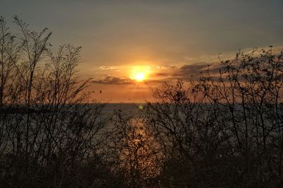 Scenic view of lake against orange sky