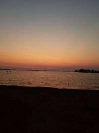 Scenic view of sea against clear sky during sunset