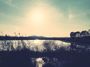 Scenic view of lake against sky during sunset