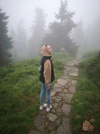 Full length of young woman standing on land