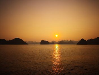 Scenic view of sea against romantic sky at sunset