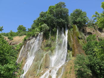 Scenic view of waterfall against clear sky