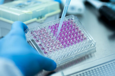 Cropped hand of scientist working on table