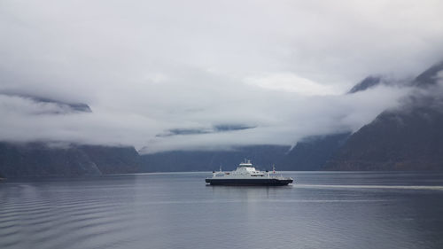 Ship sailing in sea against sky