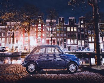 Cars on illuminated street at night