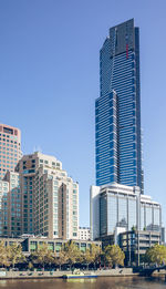 Low angle view of modern buildings against clear blue sky
