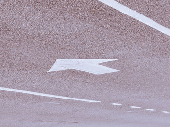 High angle view of arrow sign on road