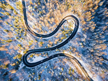 Aerial view of road amidst forest during winter