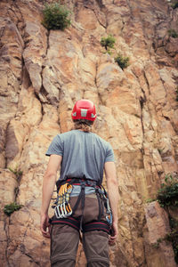 Rear view of man holding rock