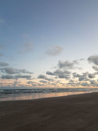 Scenic view of beach against sky during sunset