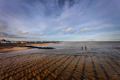 Scenic view of beach against sky during sunset