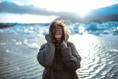 Mid adult woman standing at beach