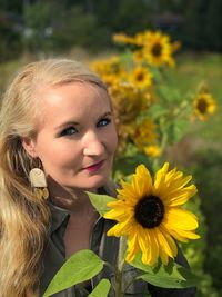 Portrait of woman with yellow flower