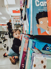 Full length of boy looking away at store