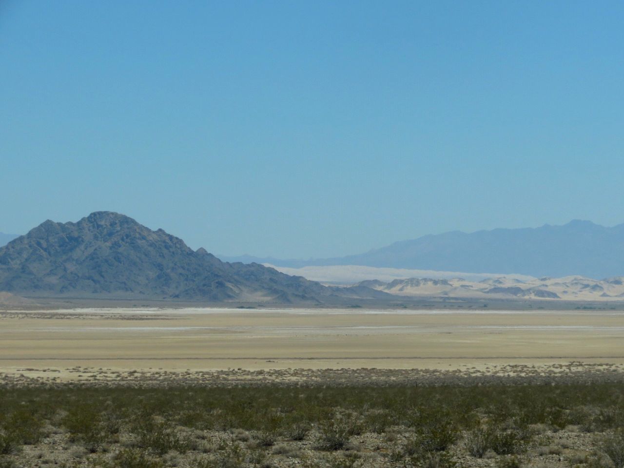 copy space, mountain, clear sky, tranquil scene, blue, landscape, scenics, tranquility, non-urban scene, remote, mountain range, day, beauty in nature, outdoors, nature, solitude, countryside, rocky mountains, no people, physical geography, country road, tourism, geology