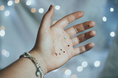 Cropped image of woman with glitter on hand